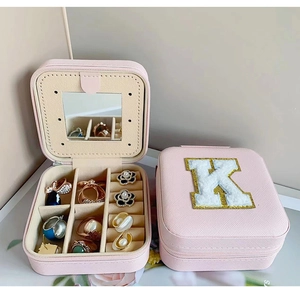 Pink portable jewelry box with letter K embroidery, built-in mirror and ring slots