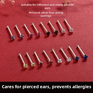 Close-up of 999 sterling silver four-claw stud earrings set with colorful zircon stones