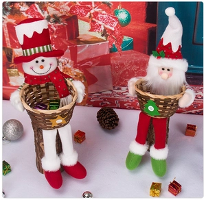 Detail of Christmas candy baskets featuring Santa Claus and snowman plush decorations
