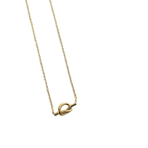 Elegant gold knot pendant necklace in titanium steel on a clean white background