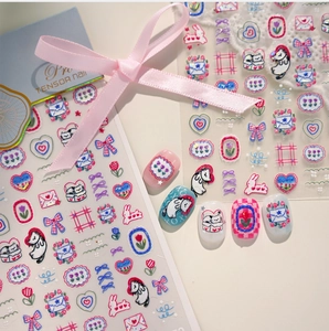 Detail of cartoon nail stickers featuring cat and tulip motifs with sample manicure display