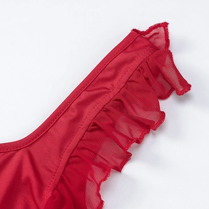 Macro detail of red ruffled mesh stitching and fine sewing on a stylish slit dress