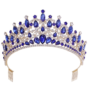 Detailed view of the gold-tone bridal crown with blue gemstones and white rhinestones