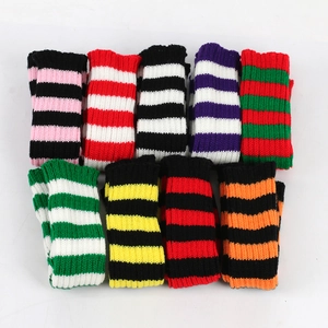 Flat lay of nine pairs of striped knitted arm warmers in various vibrant color combinations
