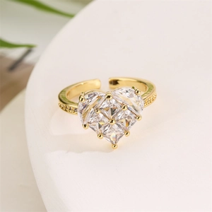 Macro shot of gold-plated heart ring featuring pear-shaped zircons and a pavé diamond band