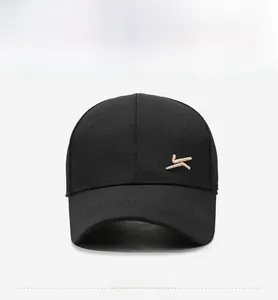 Detailed close-up of the black baseball cap showing the intricate KOMONT brand embroidery