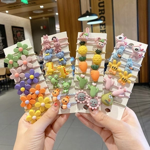Close-up of colorful seamless elastic hair ties with cute resin animal and flower charms