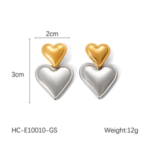 Detailed view of two-tone heart earrings in gold and silver finish with size markings
