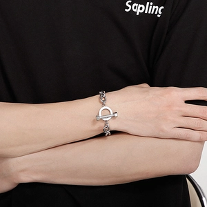 Macro detail of industrial stainless steel T-bar toggle clasp and thick chain bracelet