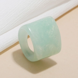 Macro detail of thick mint green resin ring showing smooth texture and jade-like finish