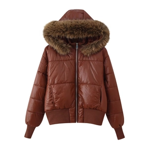Detail of a caramel winter jacket with faux fur hood and ribbed cuffs on white backdrop