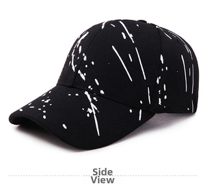 Detail shot of black graffiti baseball cap featuring stylish white paint splash textures