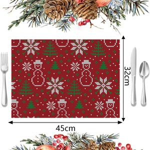 Detail of red Christmas placemat featuring snowman and snowflake motifs, 45cm x 32cm size