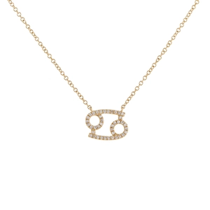 Close-up of golden zodiac necklace featuring a sparkling Cancer sign pendant with zircons