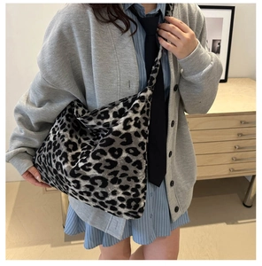 Detailed view of leopard print canvas tote bag on model for casual college style look