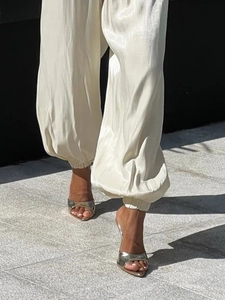 Chic cream white satin harem pants with glossy finish and elasticized ankle cuffs