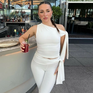 Women's chic white one-shoulder tie top and slim high-waist pants set for stylish summer wear
