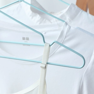 Light blue non-slip metal clothes hanger with shoulder grooves for thin straps