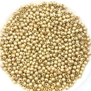 Macro shot of gold stardust finish round beads for DIY jewelry making accessories