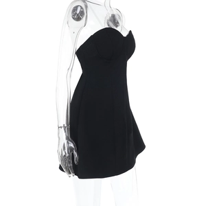 Side view of black strapless mini dress with slim fit and open back design