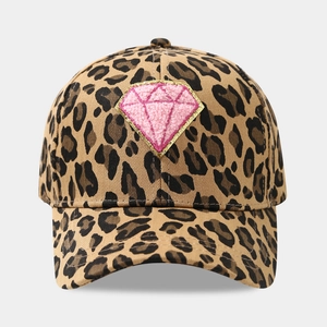 Close-up of leopard print baseball cap featuring pink diamond patch with gold embroidery