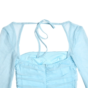 Detail of light blue glitter mesh dress with square neck and lace-up back design
