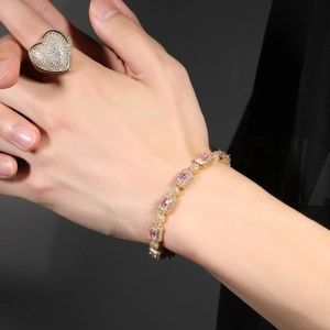 Detail of hip hop gold plated heart ring with 3A zircon stones and matching bracelet
