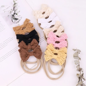 Close-up of 8-pack lace bow baby headbands in neutral colors with soft nylon bands
