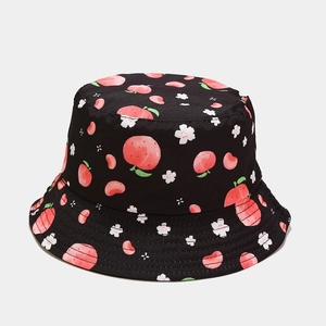 Top-down view of reversible black bucket hat with pink peach and white flower patterns