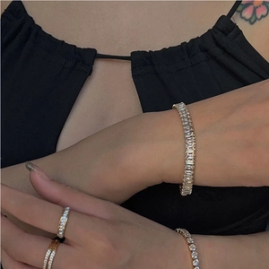 Gold-plated stainless steel bracelet set featuring radiant cubic zirconia in geometric design