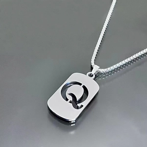 Detail of silver stainless steel box chain with square cutout letter Q pendant necklace