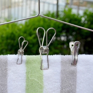Outdoor view of stainless steel spring clips for drying laundry on a rack