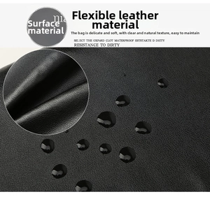 Detail of waterproof laptop bag showing durable litchi grain texture and flexible leather