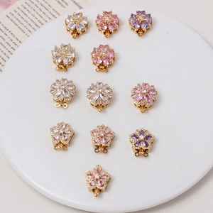 Macro view of flower-shaped zirconia clasps for DIY jewelry in gold-plated copper