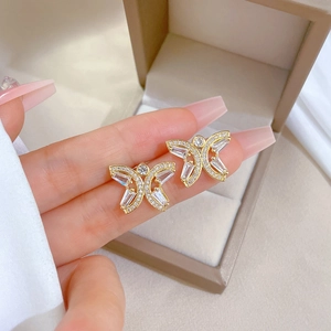 Luxurious gold butterfly earrings set with sparkling cubic zirconia on a jewelry box