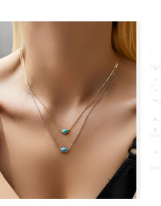 Detail of layered gold and silver s925 necklaces with turquoise pendants on model
