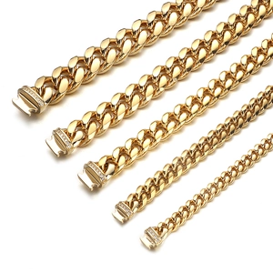 Detail of five golden Cuban link chains with diamond-encrusted clasps on white backdrop