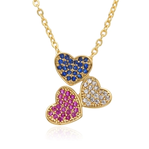 Macro shot of 14K gold-plated heart pendant with blue, pink and white cubic zirconia