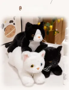 Detailed view of fluffy plush cats in white, black and tuxedo styles with realistic eyes