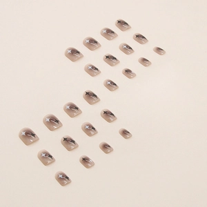 Short square press-on nails with brown gradient and black and white star patterns