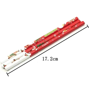 Detailed view of three 17.2cm red wooden pencils with Christmas patterns and engravings