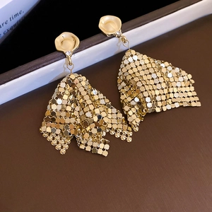 Macro shot of gold geometric triangle mesh drop earrings with sparkling rhinestone detail