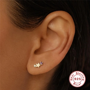 925 sterling silver star stud earring with purple birthstone on model's ear