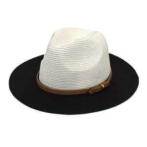 Detailed close-up of a two-tone straw fedora with a stylish brown leather buckle band