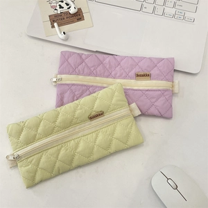 Detailed close-up of quilted candy color stationery bags in purple and soft green colors