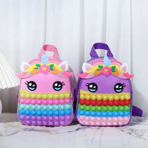Detail of pink and purple unicorn pop-it backpacks featuring rainbow silicone bubbles