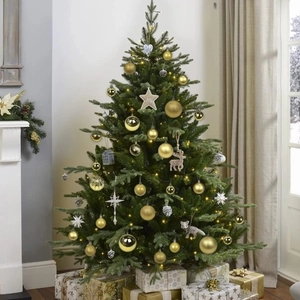 Luxurious Christmas tree set with gold ornaments and white stars in a warm interior