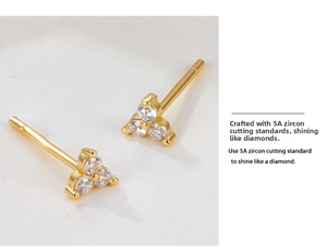 Detailed macro of 5A zircon stud earrings in a three-stone gold flower arrangement