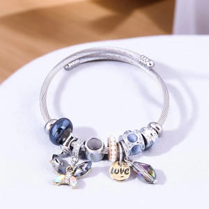 Detail of silver beaded bracelet featuring butterfly charms and LOVE pendant charms