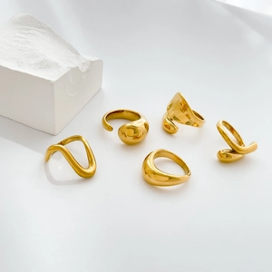 Macro shot of 5-piece minimalist gold organic rings with polished curved designs